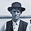 John P. Young standing on boat with oar